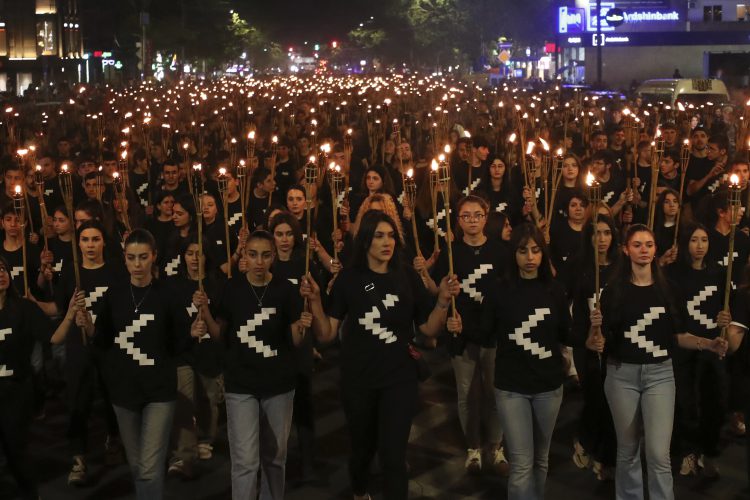 A torchlight procession marches during a demonstration in Yerevan, Armenia, Sunday, April 23, 2023, to commemorate the estimated 1.5 million Armenians killed in Ottoman Turkey more than a century ago. (Hayk Baghdasaryan/Photolure via AP)